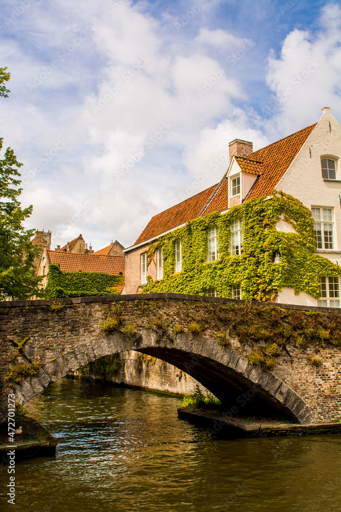 Medieval stone bridge on canal, on canal, Bruges, West Flanders, Belgium.