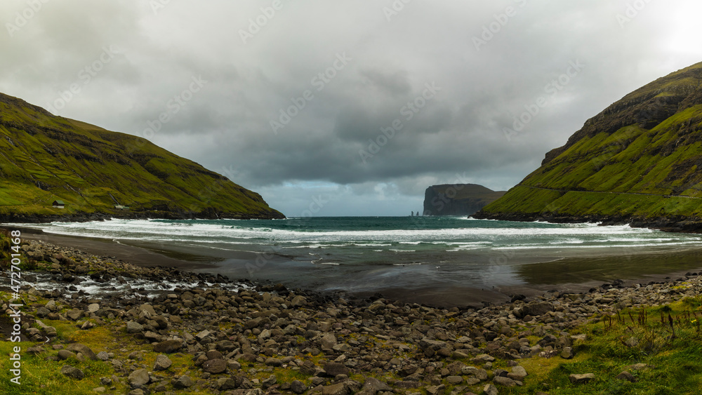 Obraz premium Europe, Faroe Islands. View during a storm of Eidiskollur and the twin stacks of Risin og Kellingin from the village of Tjornuvík on Streymoy Island.