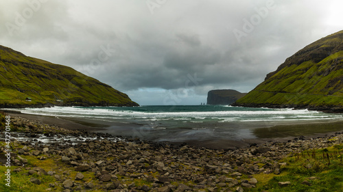 Europe, Faroe Islands. View during a storm of Eidiskollur and the twin stacks of Risin og Kellingin from the village of Tjornuvík on Streymoy Island. photo