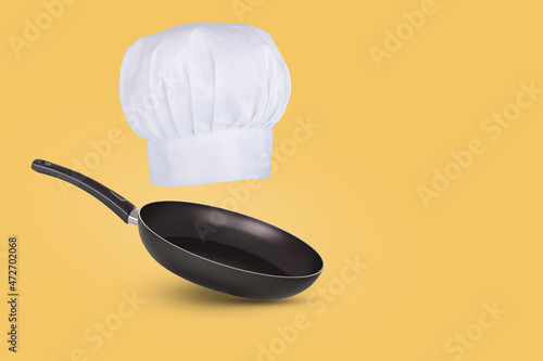 Chef hat floating in air isolated on a blue background. Creative business concept. photo
