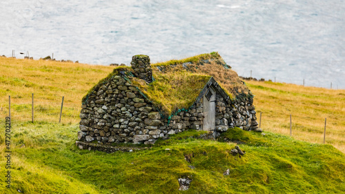 Europe, Faroe Islands, Traditional stone house on Kalsoy Island near Trollanes. photo