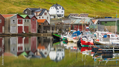 Europe, Faroe Islands. View of colorful fishing boats in the harbor of the village of Sorvagur on the island of Vagar. photo