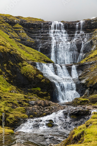 Europe  Faroe Islands. View of waterfall cascading down a hillside in the Faroe Islands.