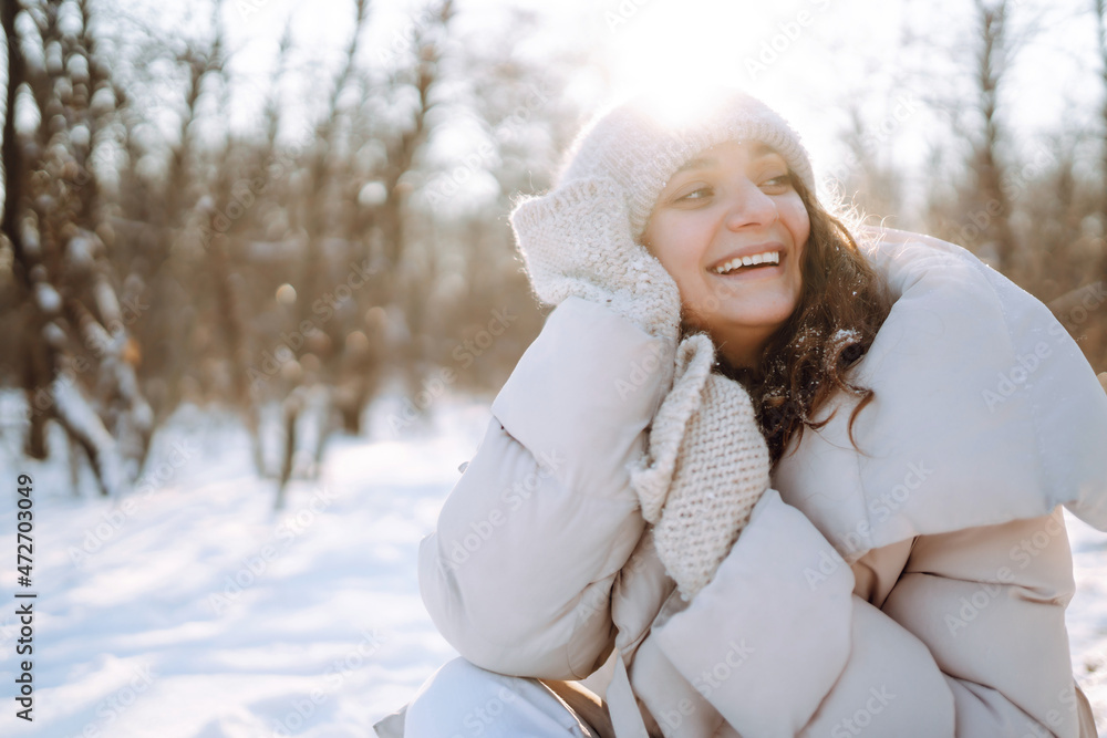 Happy woman in winter style clothes walking in the snowy park. Nature, holidays, rest, travel concept. Happy woman in winter style clothes walking in the snowy park. Nature, holidays, rest, travel concept.