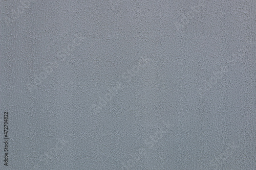 Abstract background from rough old dark gray plaster.