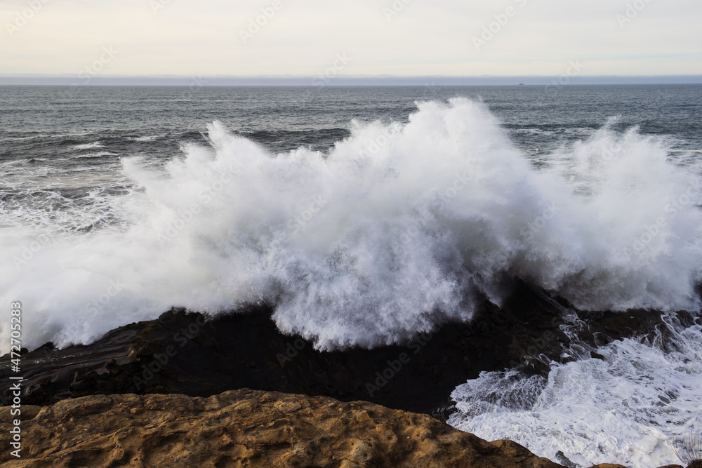 A big wave breaking on the rocks
