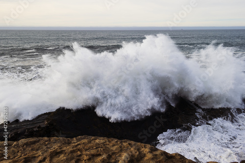 A big wave breaking on the rocks