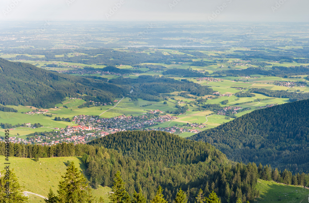 View over the foothills of the Chiemgau Alps and town Aschau in Upper Bavaria. Europe, Germany, Bavaria