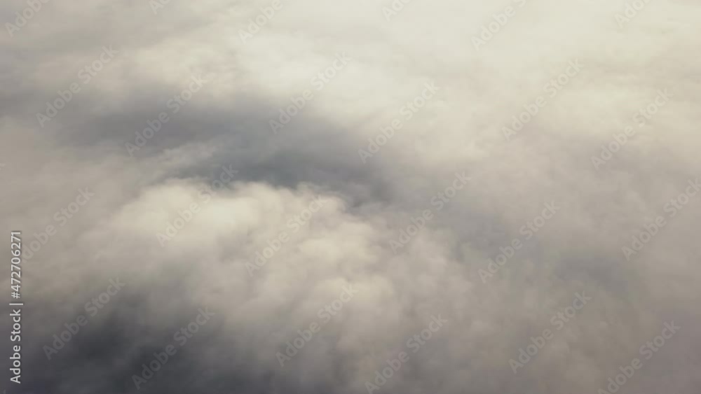 Amazing nature landscape, drone in sky. Raising above from thick fog above beautiful ocean of clouds at sunrise. Sun is rising top view the endless sea of clouds until the horizon. Amazing nature landscape, drone in sky. Raising above from thick fog above beautiful ocean of clouds at sunrise. Sun is rising top view the endless sea of clouds until the horizon.
