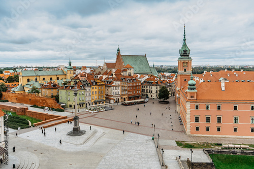 Rooftop aerial view of Royal Castle,Castle Square and Old Town,Warsaw,Poland.Historic downtown with colorful Renaissance and Baroque merchants houses.Town panorama on cloudy day.Travel urban concept