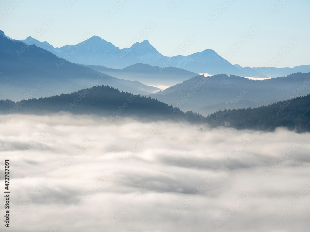 View from Mount Hoernle over a sea of fog hiding the valley of river Ammer towards Fuessen. Bavarian alps near Unterammergau in the Werdenfelser Land (Werdenfels county). Europe, Germany, Bavaria View from Mount Hoernle over a sea of fog hiding the valley of river Ammer towards Fuessen. Bavarian alps near Unterammergau in the Werdenfelser Land (Werdenfels county). Europe, Germany, Bavaria
