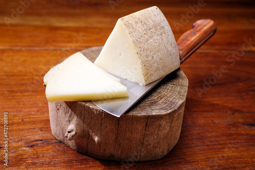 Картината върху платно Traditional Italian pecorino aged sheep milk cheese offered as close-up on a woo