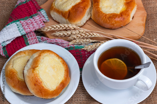Sweet buns with cottage cheese and a cup of hot tea
