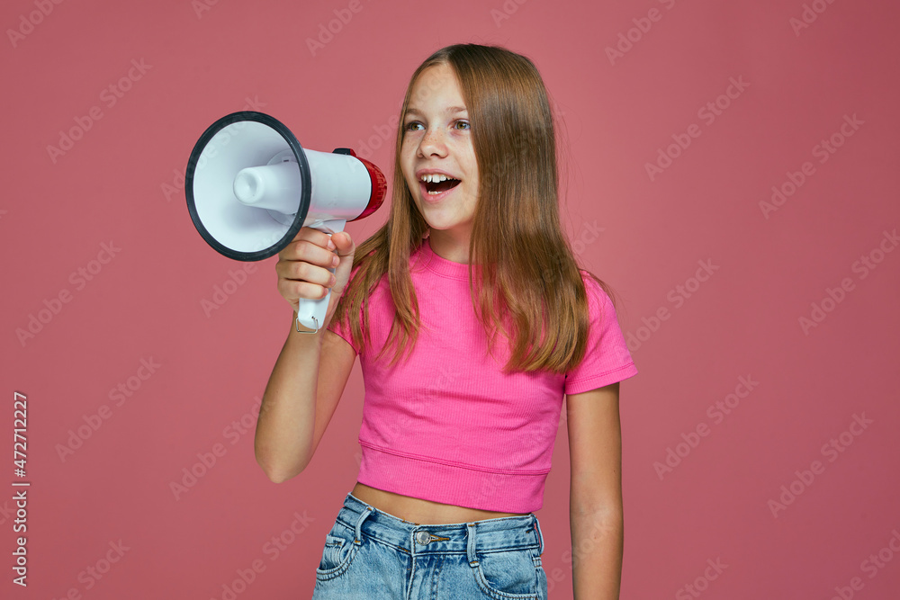 Happy cute little girl scream in megaphone news about sale discount on pink studio background. Baby store advertising Happy cute little girl scream in megaphone news about sale discount on pink studio background. Baby store advertising