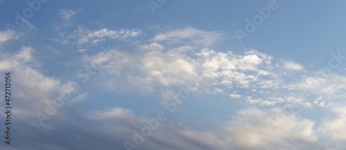 Dark blue majestic sky with big light clouds.	
