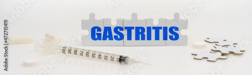On a white background lie a syringe, pills and puzzles with the inscription - GASTRITIS
