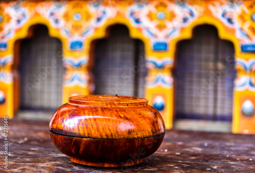 Wooden polished monk's alms bowl in the courryard of a dzong monastery in Bhutan, Asia photo