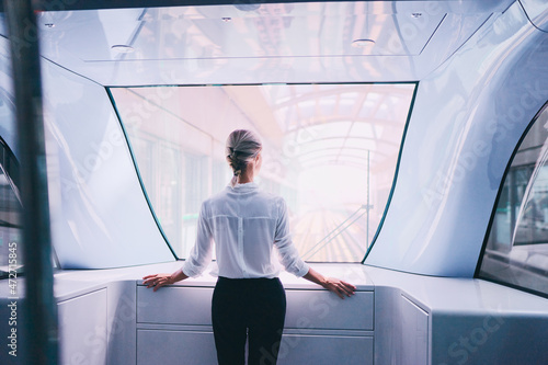 Photography Young woman traveling by the metro train looking at window.