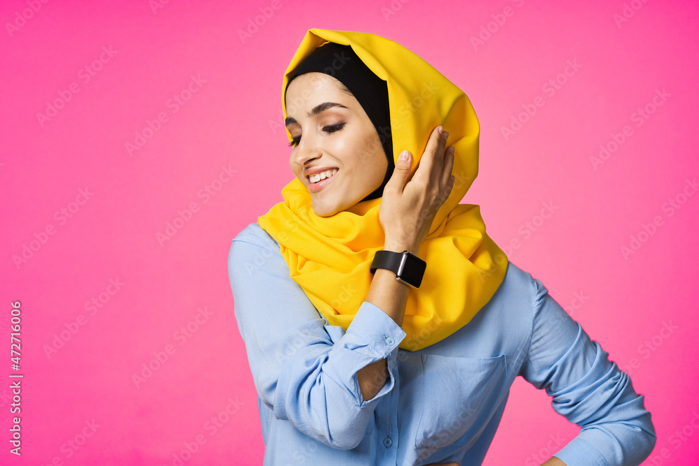 cheerful woman in yellow hijab electronic watch technology user pink background cheerful woman in yellow hijab electronic watch technology user pink background