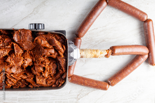 Εκτύπωση καμβά Close up isolated image of homemade sucuk or Sausage that is being stuffed into casing using electrical stuffer device
