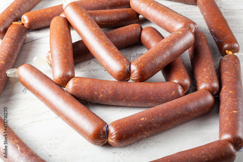 Fotografie Closeup isolated image of strings of homemade sucuk or sausage stuffed in casing and made into strings before drying