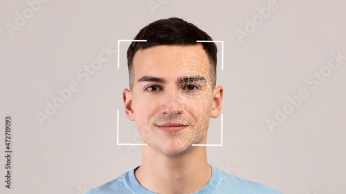Smiling young caucasian male, double exposure with id scan, isolated on light background