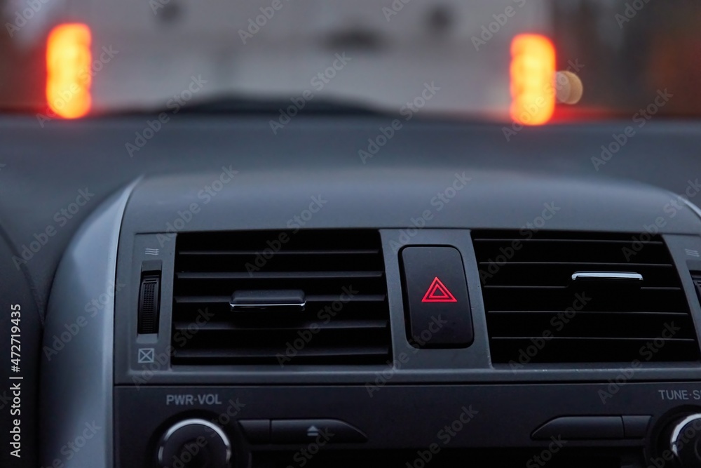 Dashboard hazard light button in stopping traffic