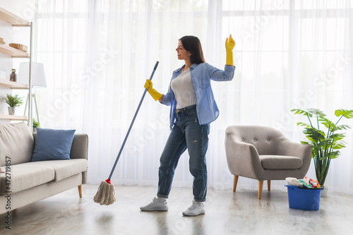 Wallpaper Mural Excited woman cleaning floor singing, dancing and holding mop Torontodigital.ca