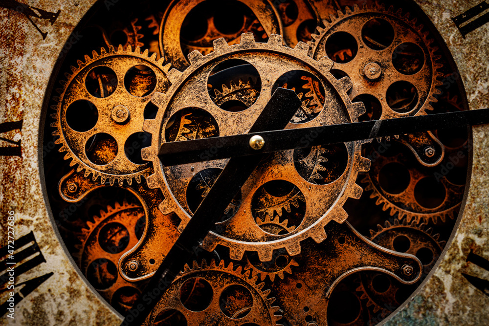 A close-up of the clockwork. Iron gears and arrows.