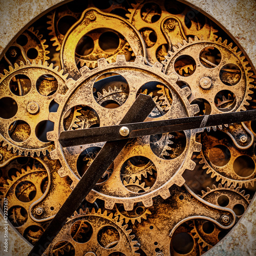 A close-up of the clockwork. Iron gears and arrows.