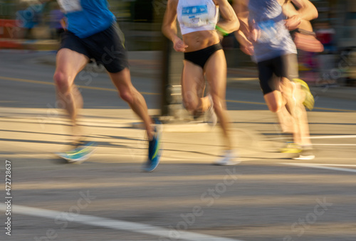 Distance Runners in an Urban Race. Competitors round a bend in a running race. Motion blur.  