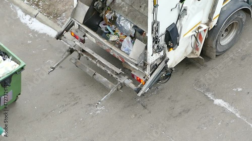 Garbage removal in residential area, loading household rubbish in garbage truck, view from above, Moscow, 24 Nov 2021