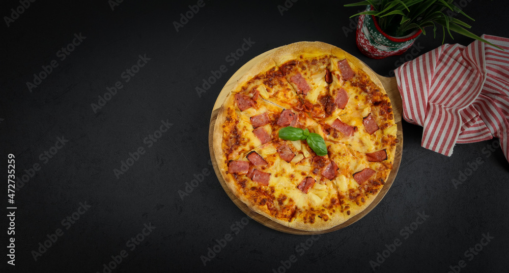 Round baked pizza on a wooden cutting board Round baked pizza on a wooden cutting board