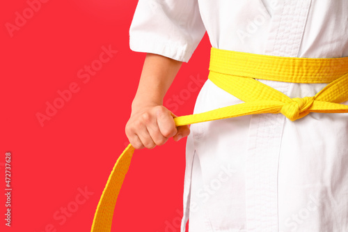 Little boy in karategi on color background, closeup