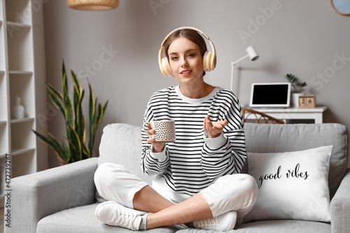 Pretty young woman drinking...
