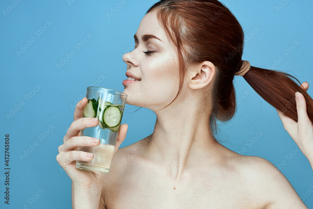 woman with bared shoulders cucumber health drink blue background woman with bared shoulders cucumber health drink blue background