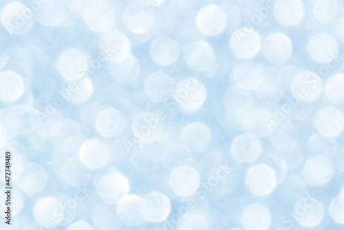 Abstract blue and white bokeh background. Christmas, New Year and all celebration background concepts. Snowfall in the winter.