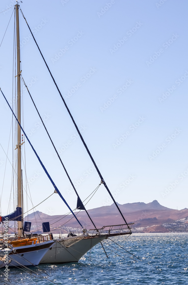 Sailboats in the blue sea against the backdrop of islands and mountains. Sports and summer vacations concept
