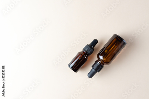 facial essential oil or serum packaging on beige Background. Beauty cosmetic product for skincare concept copy space.