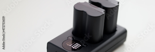 Closeup of black camera battery charger with cable