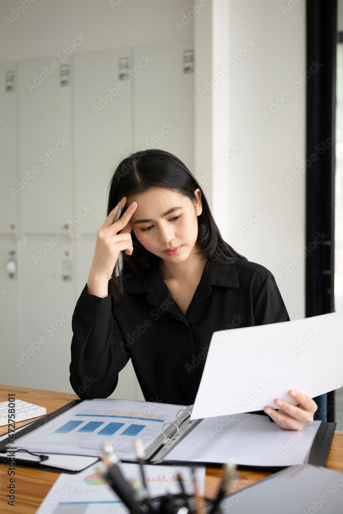 Serious female accountant working in office. Serious female accountant working in office.