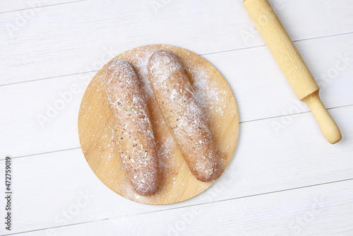 Fresh bread on wooden table. Top view with space for your text