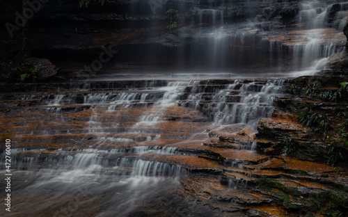 Water flowing on the layer of rocks.