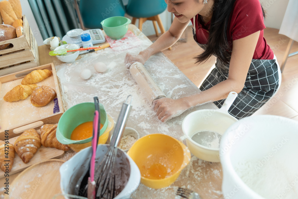 Happy woman use fresh natural products flour milk eggs kneading dough for pastries cookies by hands at modern kitchen.