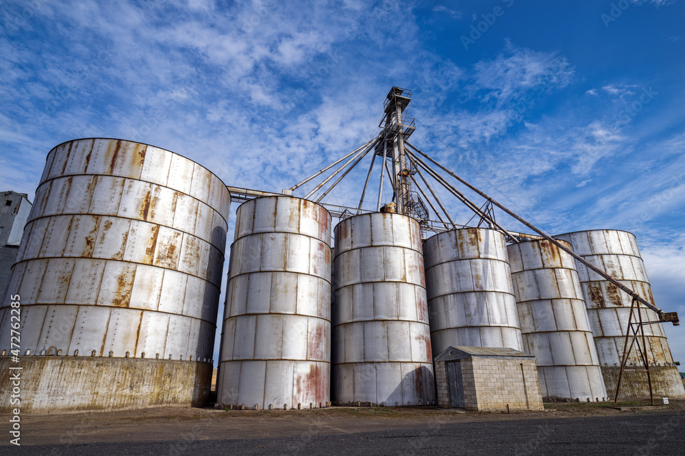 Metal bins along a gravel road at a grain elevator in southeastern Washington, USA