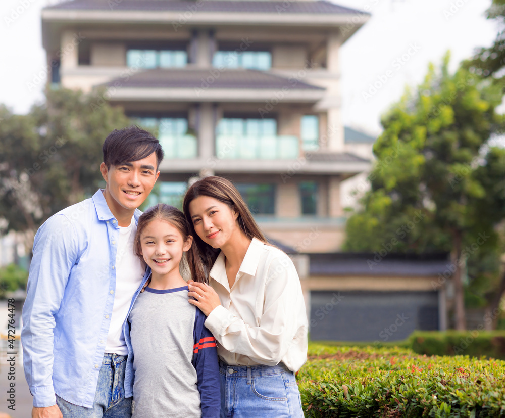 Happy asian family stand outside before their new house Happy asian family stand outside before their new house