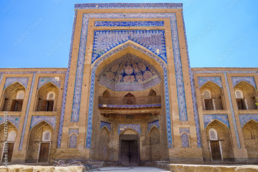 Facade portal of Muhammad Rahim Khan madrasah decorated with traditional patterns, Khiva, Uzbekistan. Niches of students' rooms are visible. It was one of largest madrasahs in city. Built in 1871