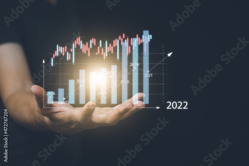 Businessman or trader is showing a growing virtual hologram stock, planning and strategy, Business growth, progress or success concept.