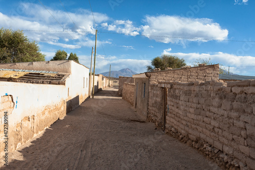 Bolivia, Altiplano, Potosi, San Juan. View of a street in the town of San Juan with mud brick homes lining the way. photo
