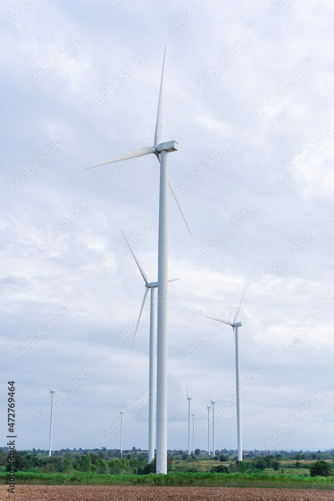 Wind turbines of global ecology with cloud background on the sky. alternative electricity source to be sustainable resources in the future. Clean energy concept saves the world Wind turbines of global ecology with cloud background on the sky. alternative electricity source to be sustainable resources in the future. Clean energy concept saves the world